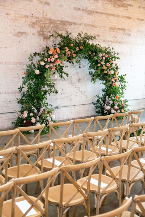 Brake & Clutch Warehouse wedding  ceremony arch on a white brick wall