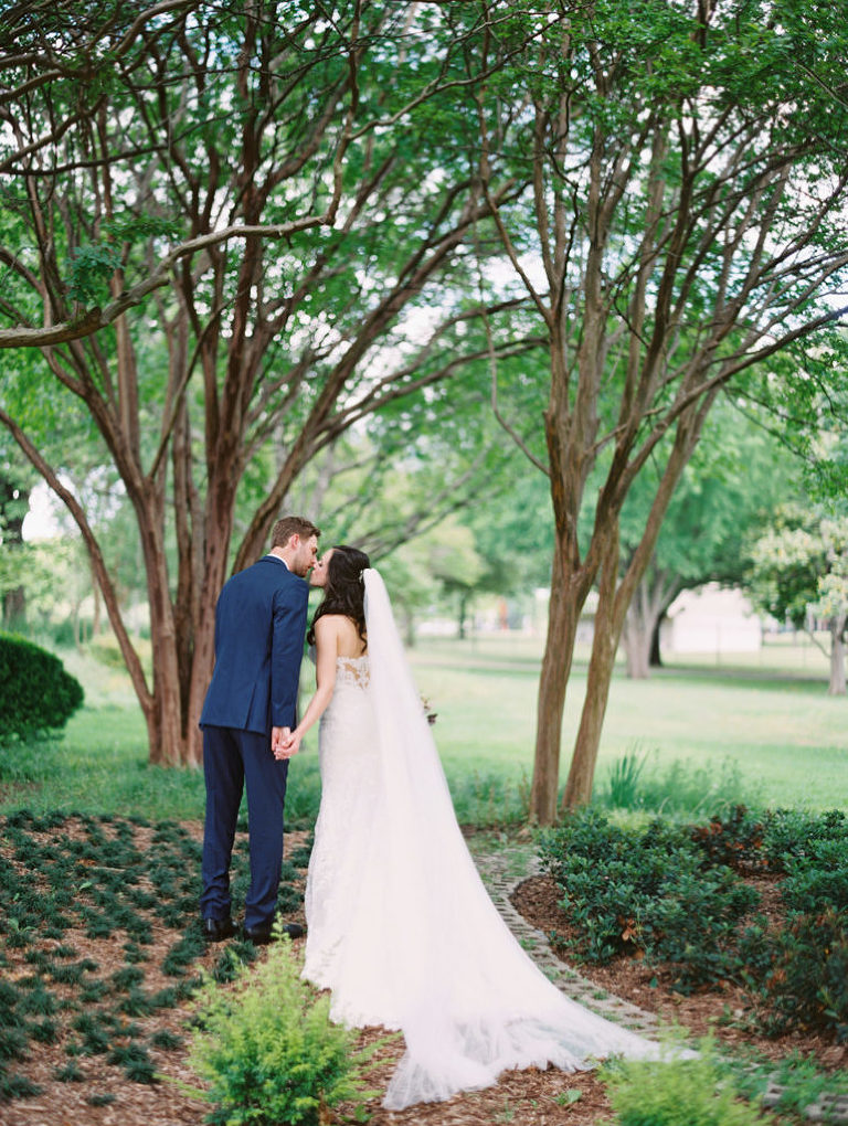 Bride and groom kissing outside Brake & Clutch Warehouse